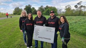 Team Prodigy holding Easy Treesie Sign